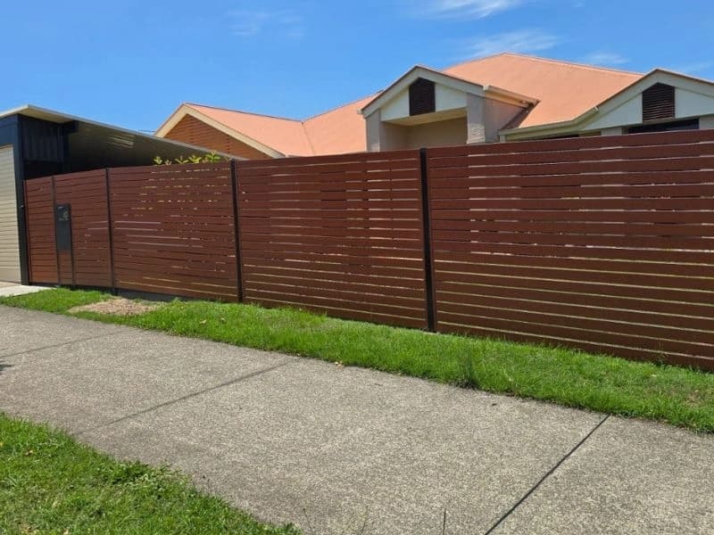 Horizontal timber slat front fence along a footpath